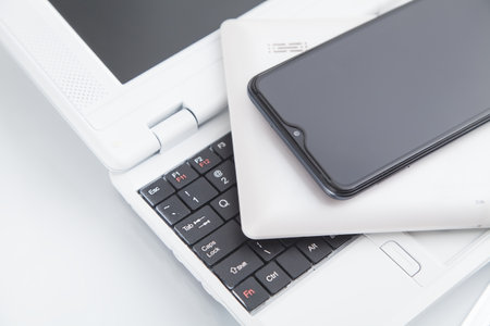 Tablet computer, smartphone on the laptop keyboard.