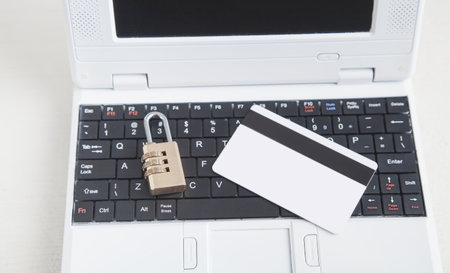 Padlock with credit card on the computer keyboard.