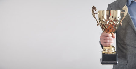 Businessman holding golden trophy. business, success