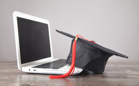 Graduation hat and laptop. Online Educationの写真素材