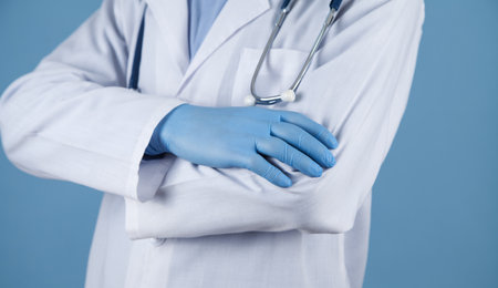 Doctor standing crossing hands in clinic.