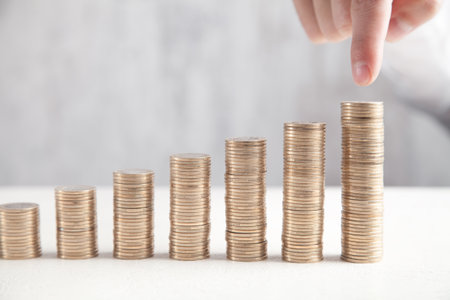 Male hand pointing stacks of coins. Growth