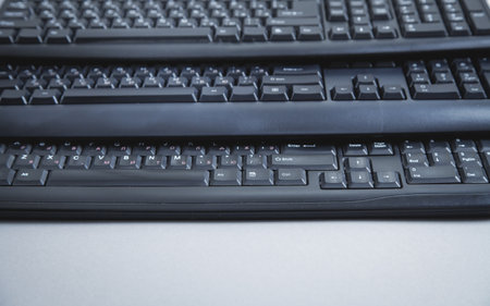 Black computer keyboards on gray background.の写真素材