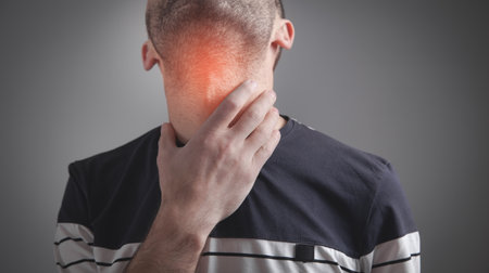 Caucasian man having throat pain.