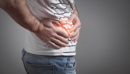 Caucasian man suffering from belly pain.
