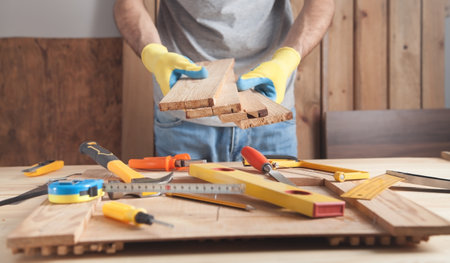 Carpenter holding wooden planks. woodworking industryの写真素材