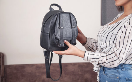 Caucasian woman with a black bag at home.の写真素材