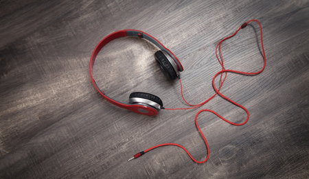 Red headphones on the wooden background.の写真素材