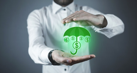Man protect umbrella with a dollar sign. money protection. financial insuranceの写真素材