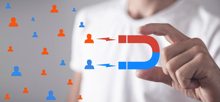 Male hand holding magnet attract customers. business conceptの写真素材