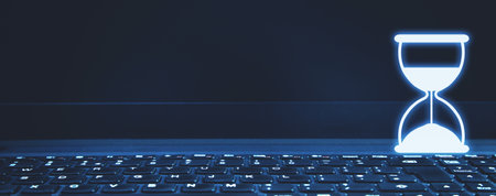 Hourglass icon on laptop keyboard. time management. business