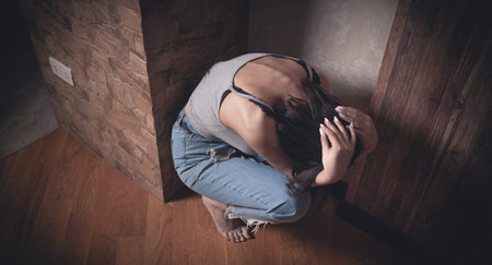 Stressed and scared young woman at home.の写真素材