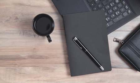 office workplace. Laptop, coffee, notepad, pen, wallet