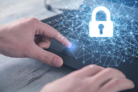 Male hands typing on laptop keyboard. network security