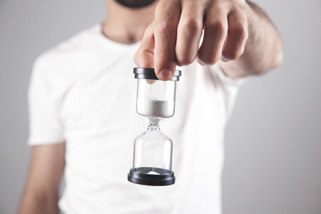 man holding hourglass. Dead line concept
