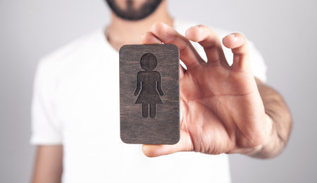 Caucasian man showing wooden female symbol.の写真素材