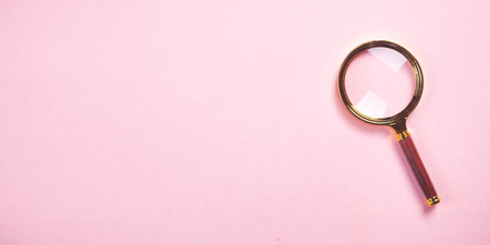 Magnifying glass on the pink background.の写真素材