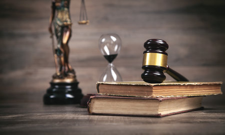 Statue of Lady Justice, hourglass, book and gavel.の写真素材