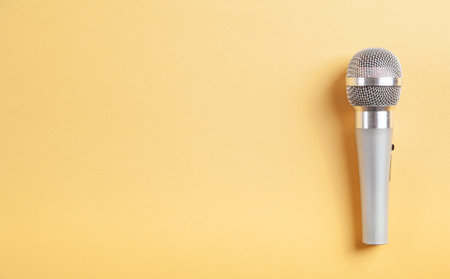 Microphone on the yellow background. Space for your textの写真素材