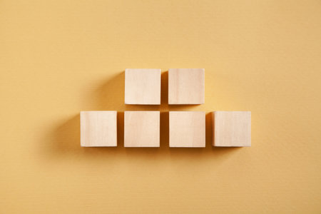 Wooden cubes on yellow background.の写真素材