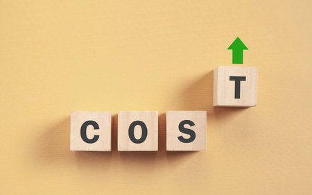 Wooden cubes with a Cost word and up arrow.の写真素材