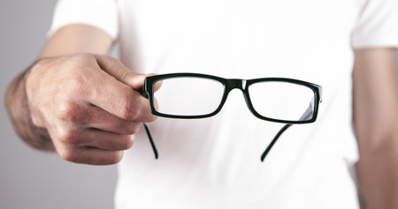 Caucasian professional doctor showing eyeglasses.の写真素材