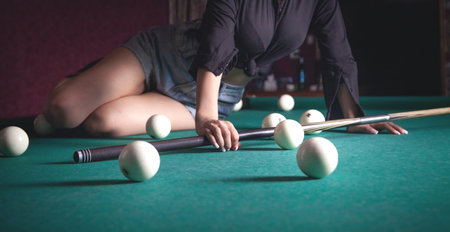 Caucasian young girl playing billiards.