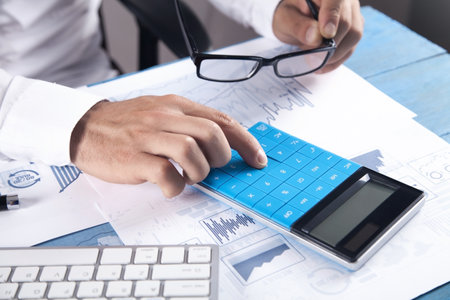 Businessman using calculator for analysis marketing plan. business, accountingの写真素材