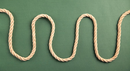 Brown rope on green background.