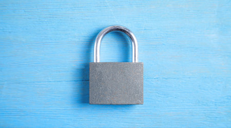 Metal padlock on the blue background.