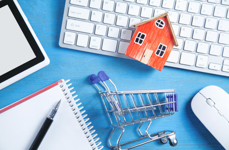 House model, shopping cart and business objects. buying houseの写真素材