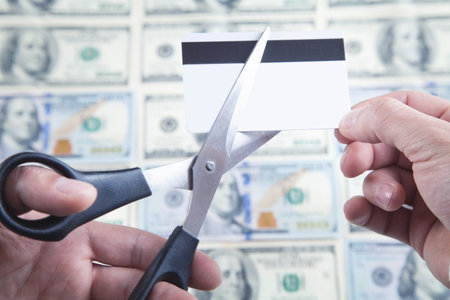 Man cutting credit card with scissors.の写真素材