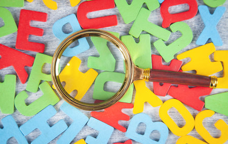 Magnifying glass with a colorful letters.の写真素材