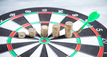 Coins and target dartboard. business strategy.の写真素材