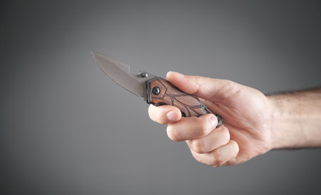 Male hand holding a hunting knife.の写真素材