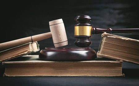 Judge gavel and book on the black background.