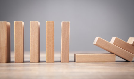 Falling wooden domino. business. crisis. riskの写真素材