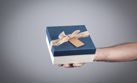 Male hand holding gift box. Christmas. Surprise