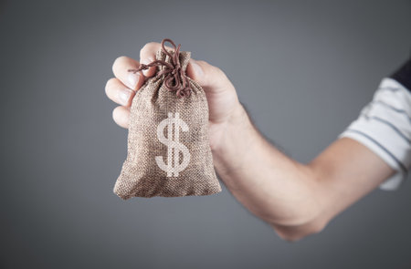 Caucasian man holding money bag.