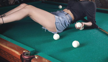 Woman holding billiard balls on the table.