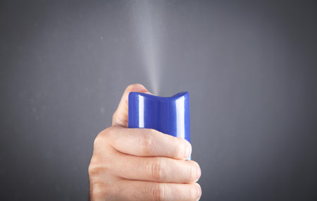 Male hand spraying air freshener.の写真素材