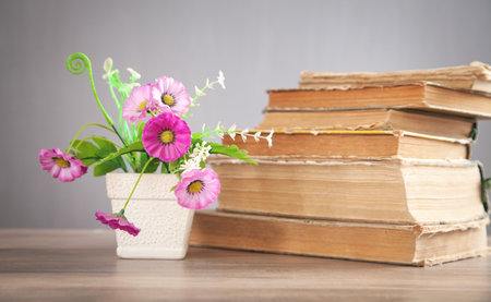Flower and book on the wooden table.の写真素材