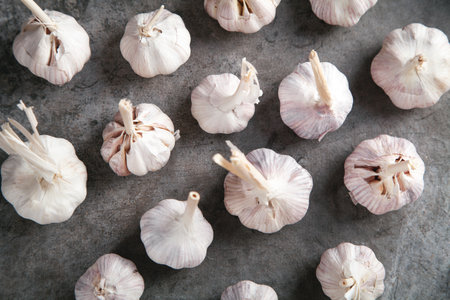 Garlic bulbs on the stone background.の写真素材