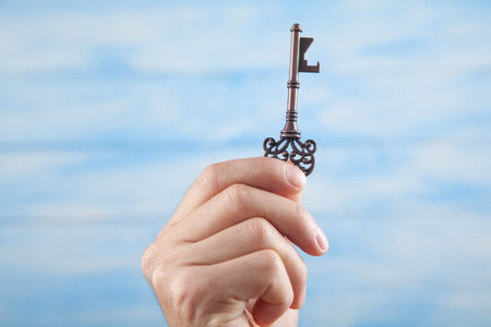 Male hand holding old key. business. successの写真素材