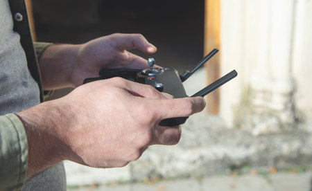 Man holding a remote control of drone.