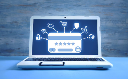 Credit card with a business and network symbols on laptop screen. online banking