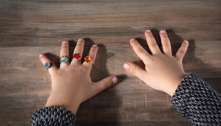 Different rings on little baby girl hands.の写真素材