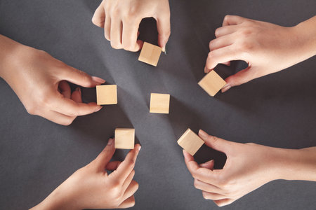 Hands of people showing wooden cubes.の写真素材