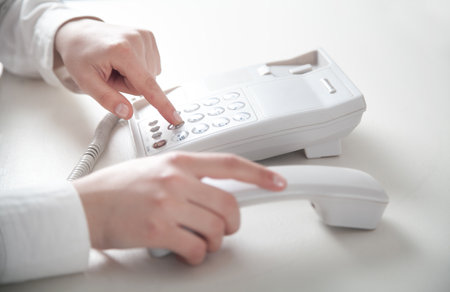 Business girl calling in office telephone.の写真素材