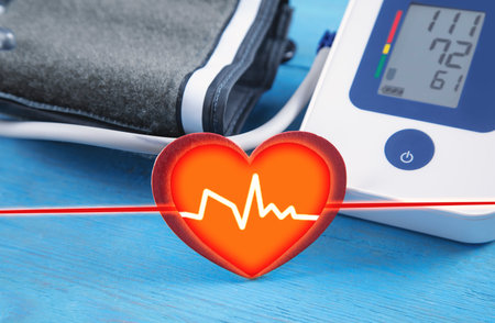 Automatic blood pressure meter and red heart on blue background.の写真素材